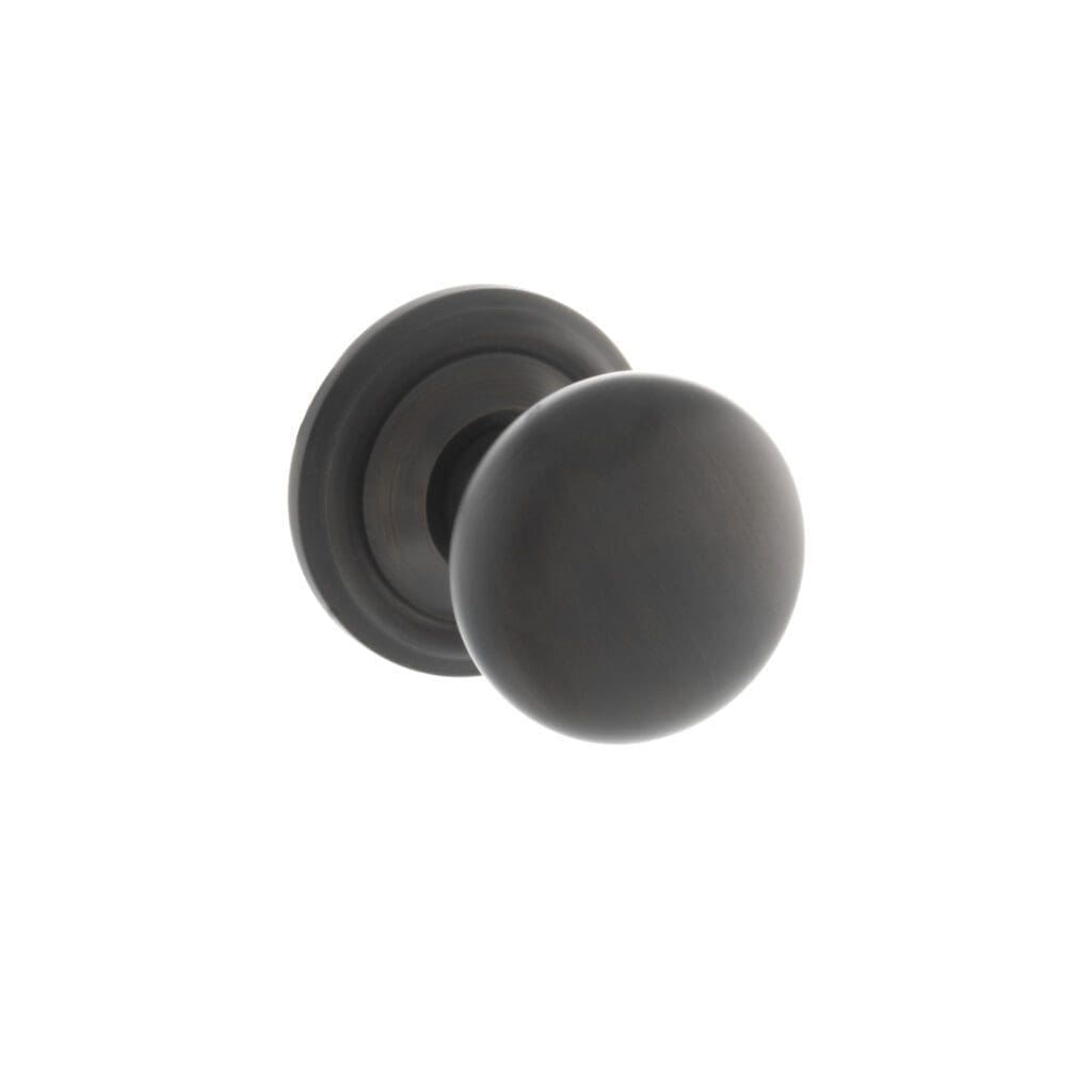 Close-up of Old English Harrogate mushroom mortice knob in Urban Dark Bronze with concealed rose.