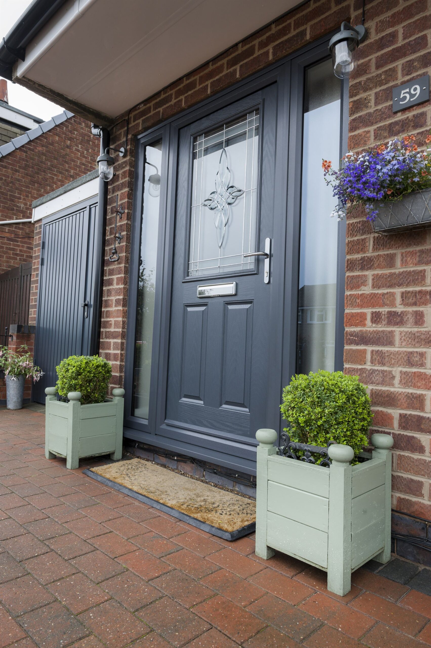 Grey composite front door with 2 panel 1 light glazed design and matching grey side panels
