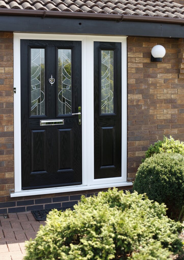 Black 2 panel 2 light composite front door with decorative glass and single side panel in white frame